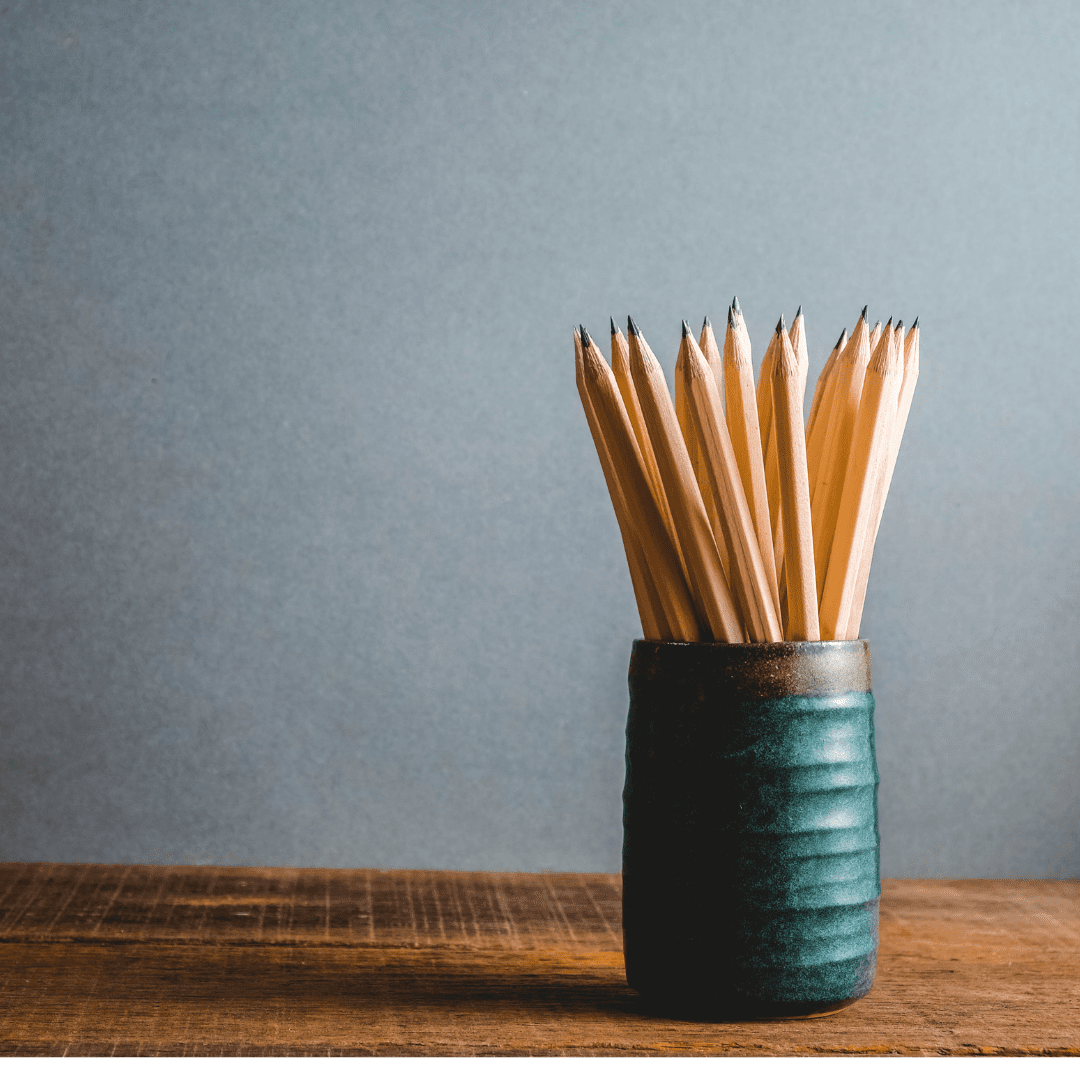 A photo of pencils in a cup on a desk